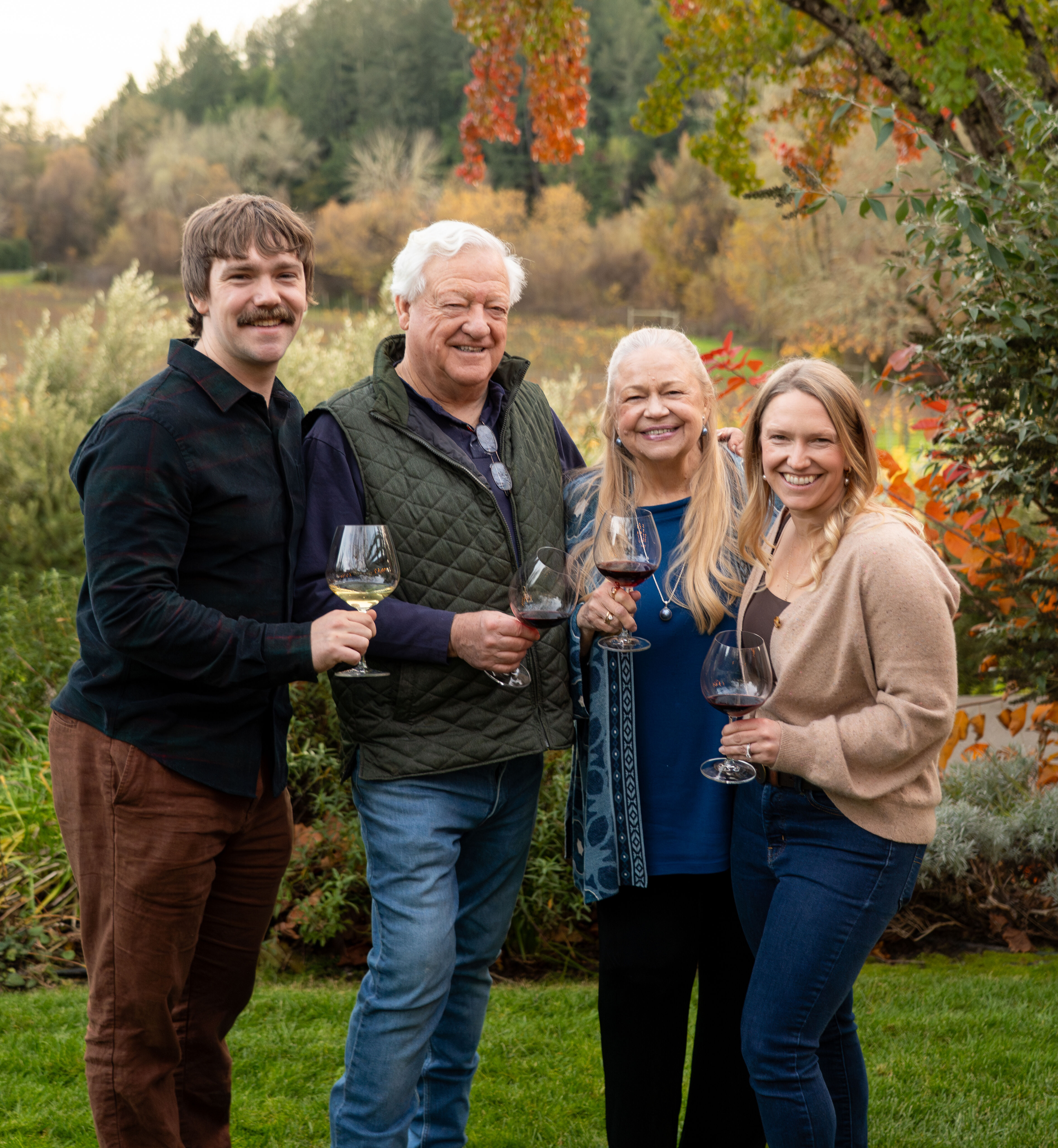 The Hartford family holding glasses of wine